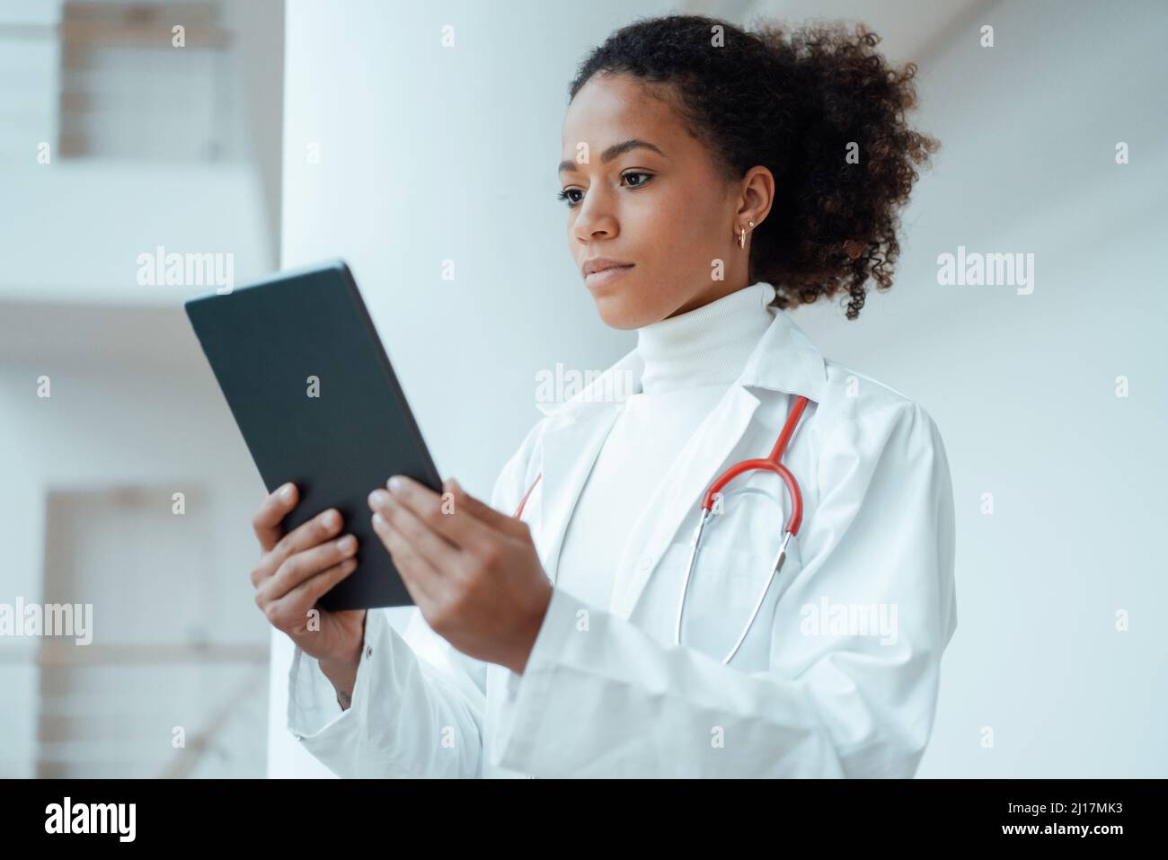 Healthcare worker using tablet PC at hospital Stock Photo
