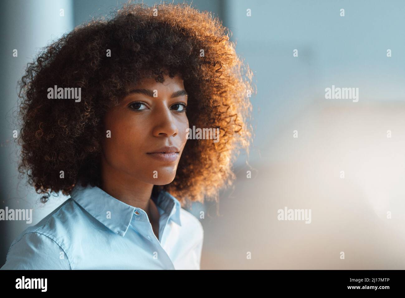Confident working woman at work place Stock Photo