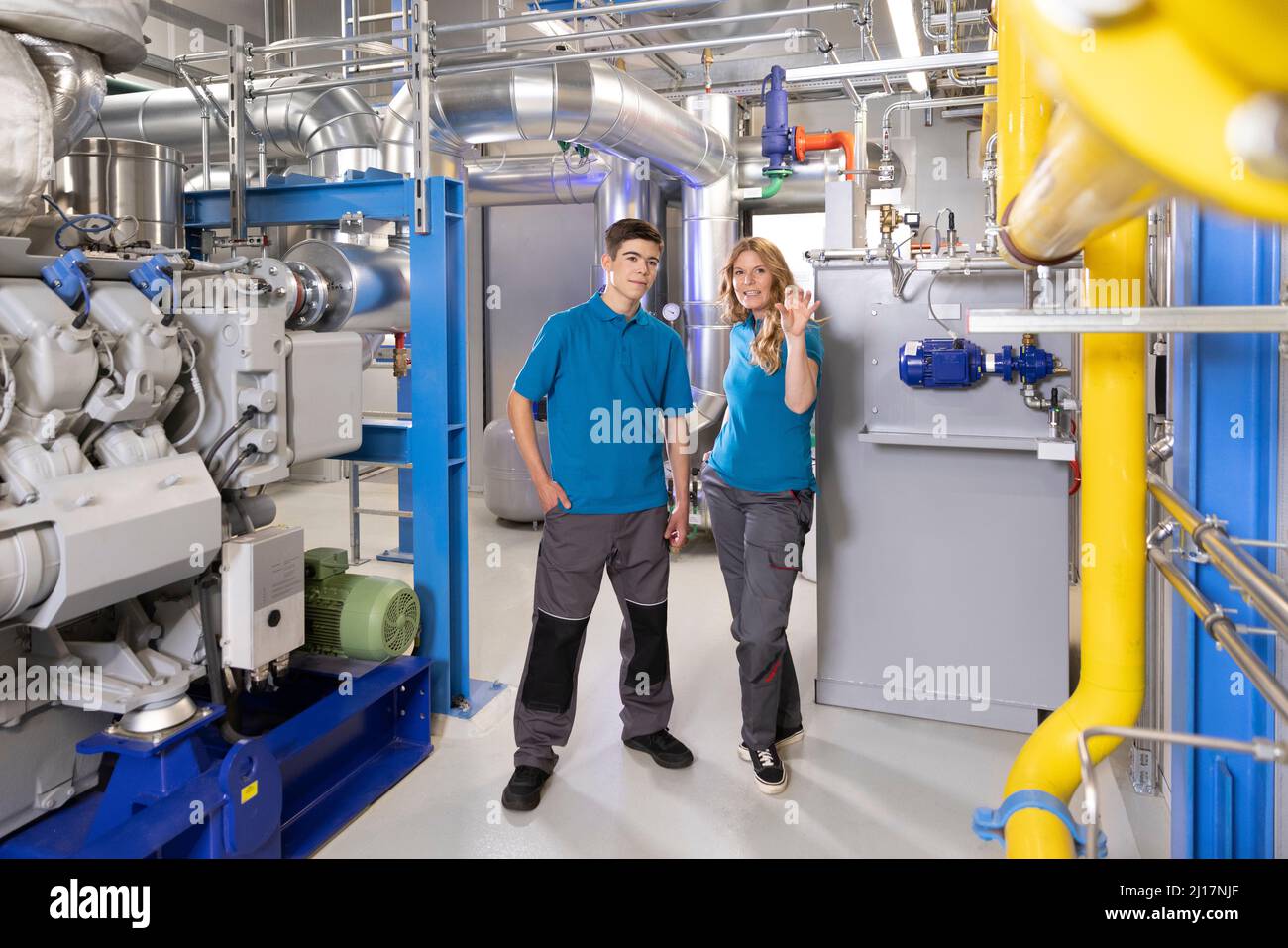 Technician explaining about machine to trainee in industry Stock Photo