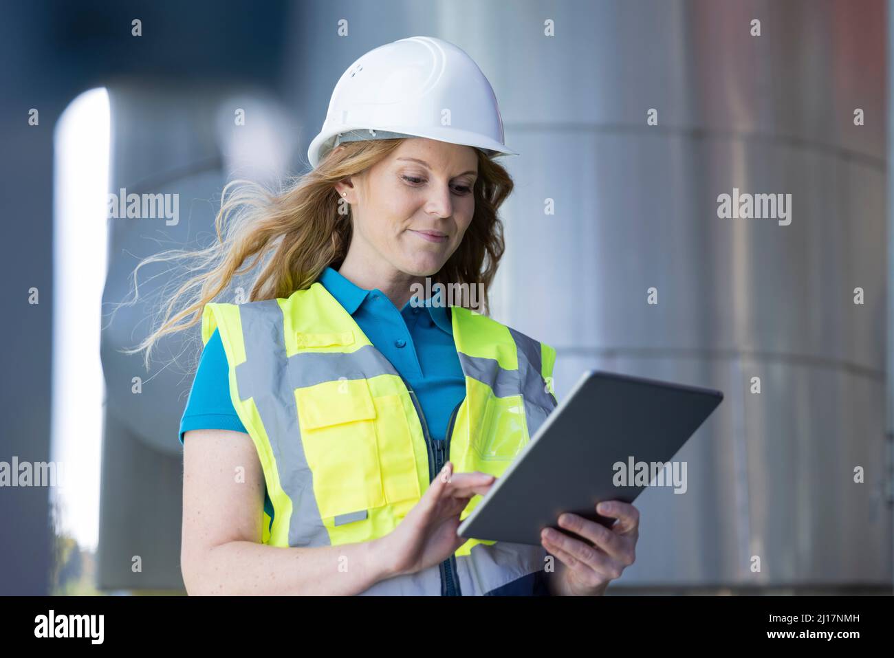 Technician using tablet PC standing in industry Stock Photo
