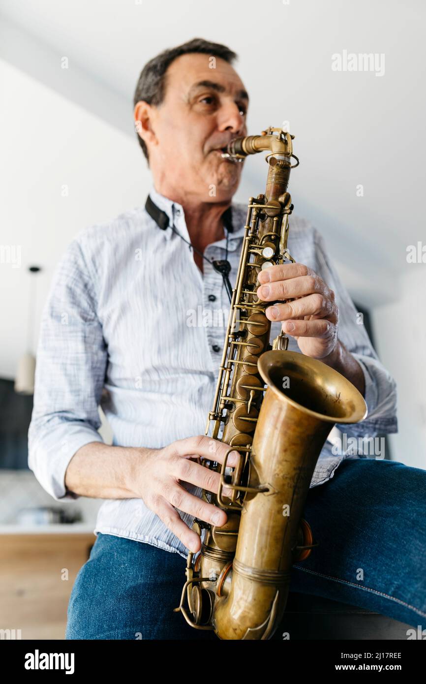 Musician playing saxophone at home Stock Photo Alamy