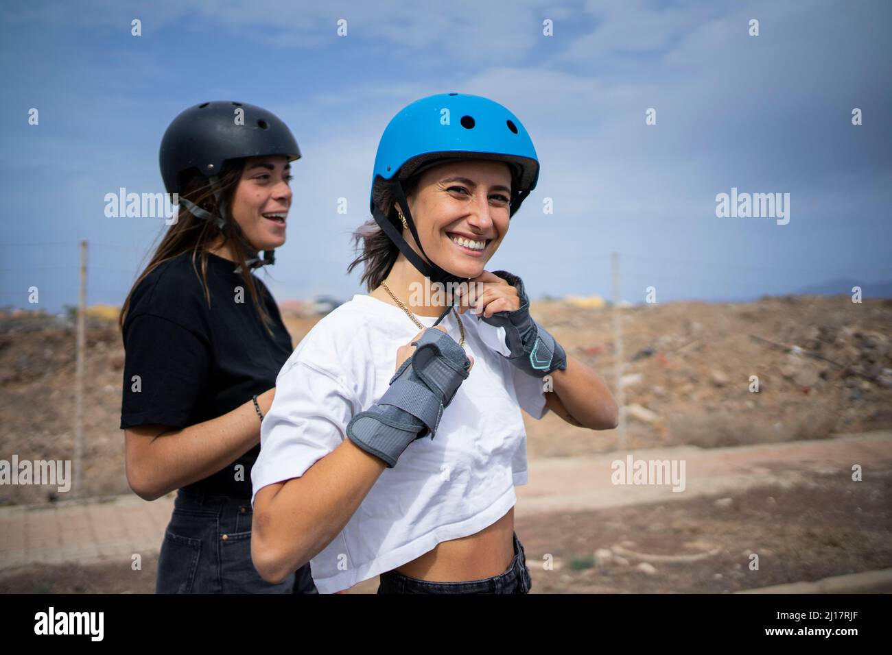 Young woman adjusting helmet hi-res stock photography and images - Alamy