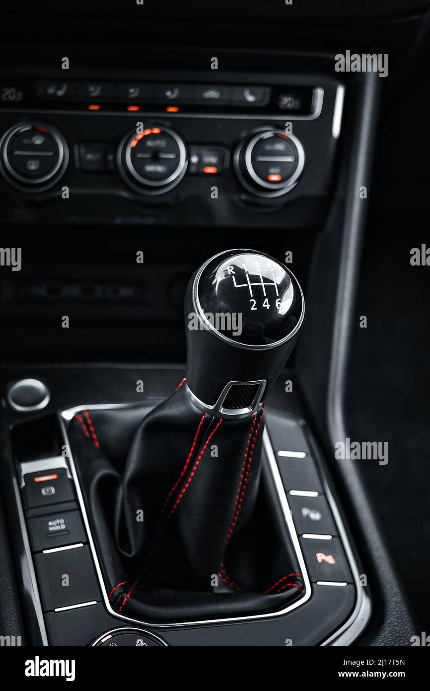 Interior of car. Lever of manual transmission in cabin of car is close-up. Dark style. Background Stock Photo