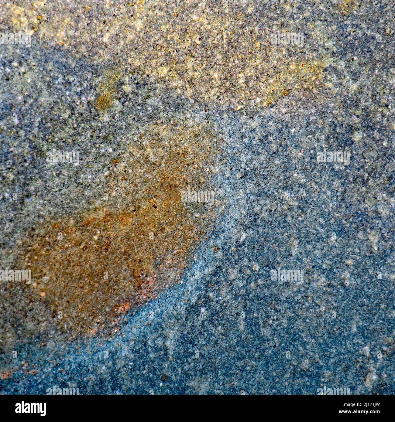 Abstract colour photograph of coastal rock the image is a colour abstract with a near impressionism style, containing rock patterns and textures. Stock Photo