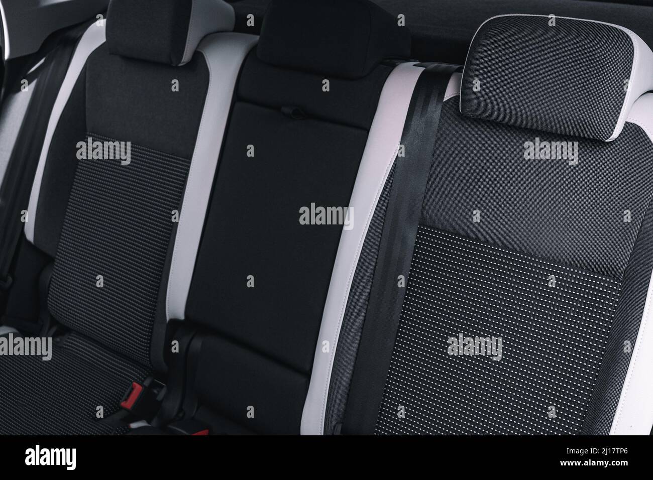 Interior of new car is viewed from inside. Passenger seats in back. Sofa and empty space. Background Stock Photo