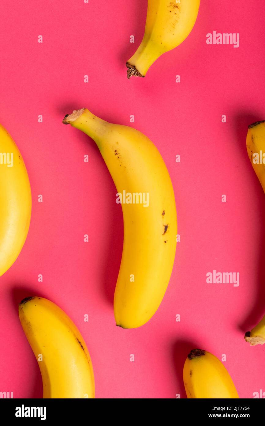 Directly above view of fresh bananas against pink background Stock Photo