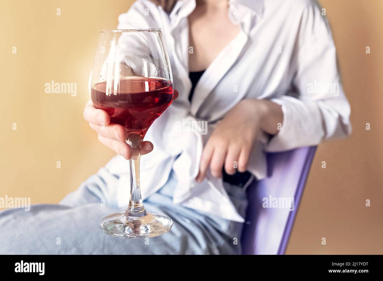 Portrait of a young woman with a glass of red wine in her hands. Spring ...