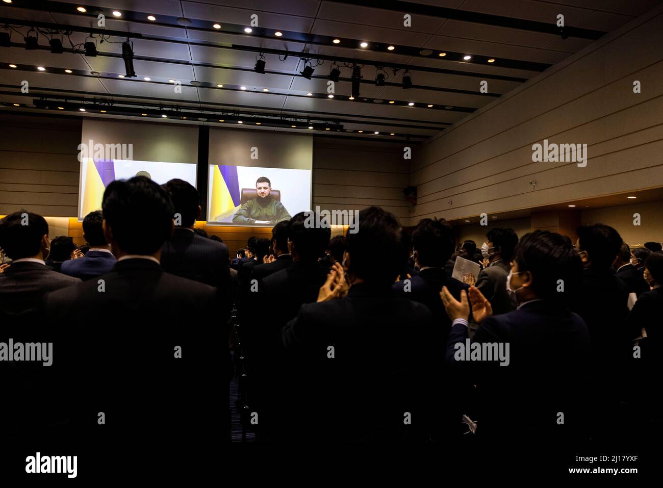 Tokyo, Japan. 23rd Mar, 2022. Members of the Japan's lower house parliament applaud at the end of Ukrainian President Volodymyr Zelensky speech via videolink at the House of Representatives office building in Tokyo. Credit: SOPA Images Limited/Alamy Live News Stock Photo