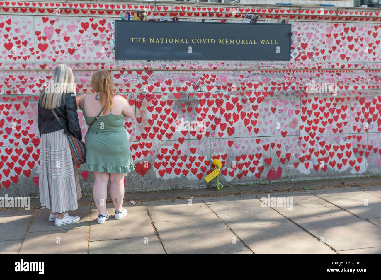 London, UK. 23rd Mar, 2022. Scenes at the National Covid Memorial on the South Bank of the River Thames, opposite the Palace of Westminster, on the second anniversary of the first national Covid-19 lockdown. A minutes silence was held at midday to mark the National Day of Reflection. Penelope Barritt/Alamy Live News Stock Photo