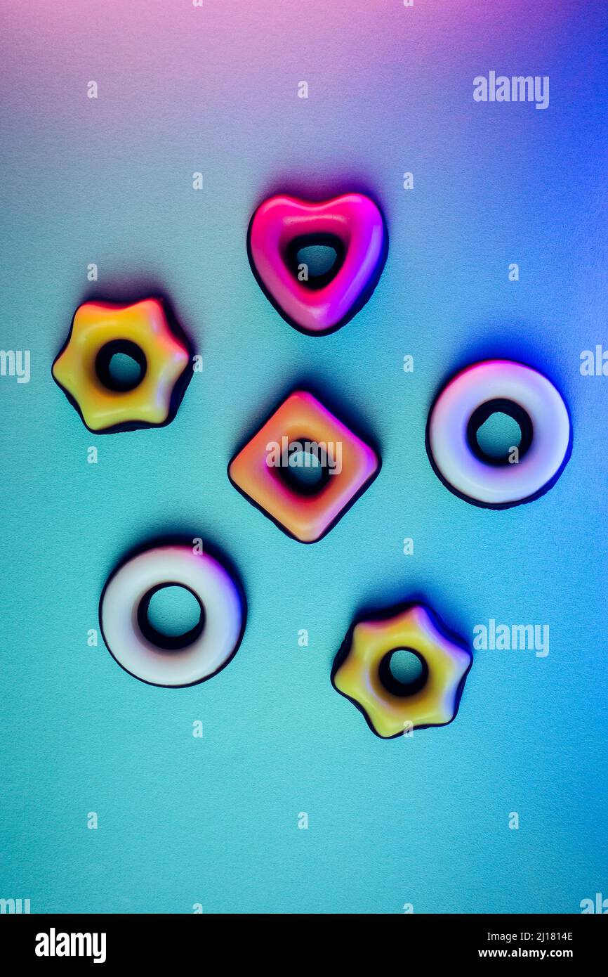The colorful donut shaped fruit candies isolated on blur background