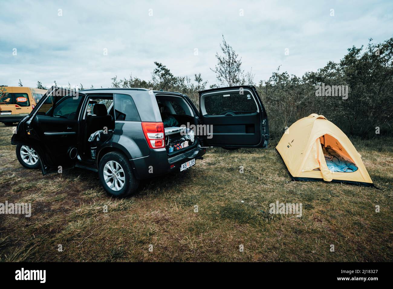 A tent near the Suzuki grand Vitara car in Iceland during a cloudy day Stock Photo
