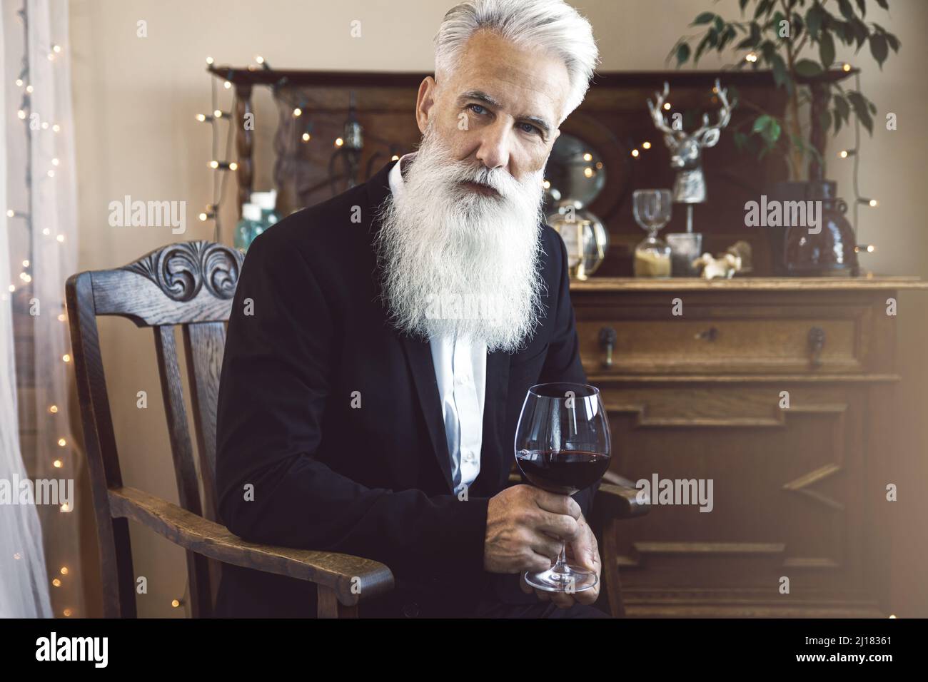 Handsome bearded senior man drinking red wine Stock Photo - Alamy