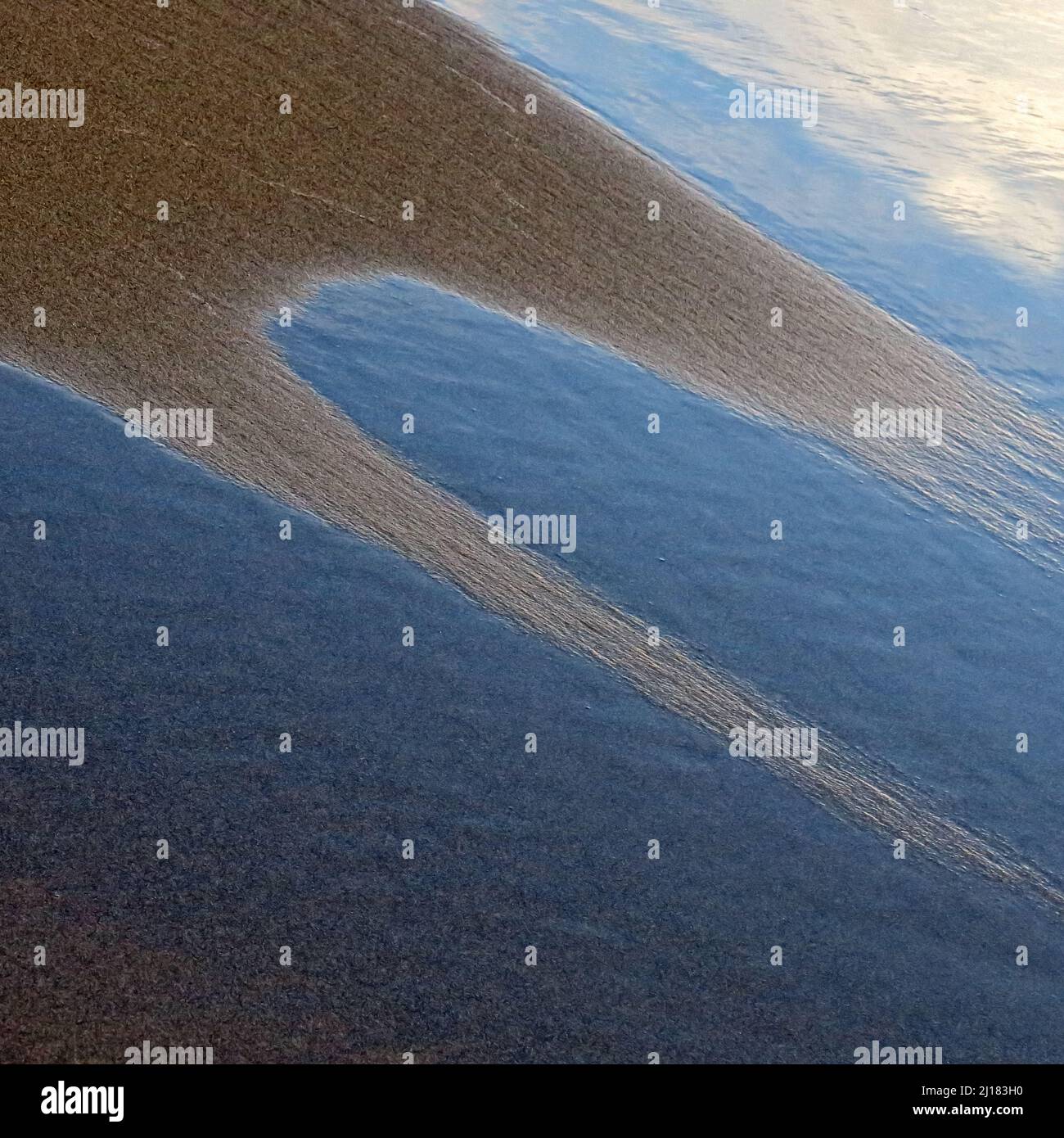 Abstract detailed tidal patterns in the sand at low tide on Penbryn beach in south west Wales UK Stock Photo
