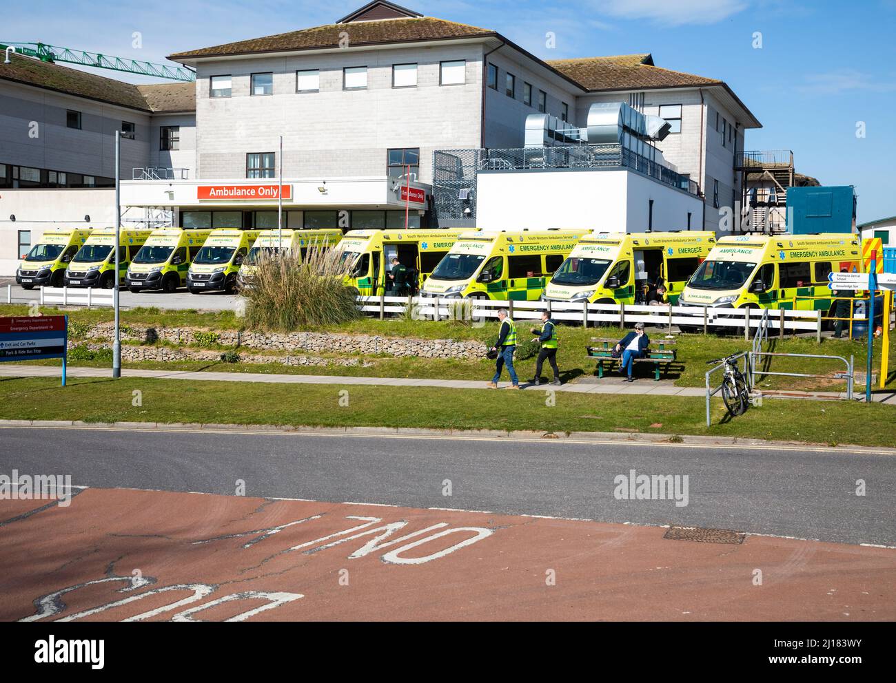 Truro, UK,23rd March 2021,Ambulances wait outside A & E at The Royal Cornwall Hospital in Treliske, Truro. Patients are having to wait their turn which can be many hours to be taken in to A&E to be seen. This is caused by an increased number of Covid 19 Patients. Visitors to the hospital have been stopped and anyone attending an outpatients appointment has to show a negative Lateral Flow Test taken that morning.Credit: Keith Larby/Alamy Live News Stock Photo