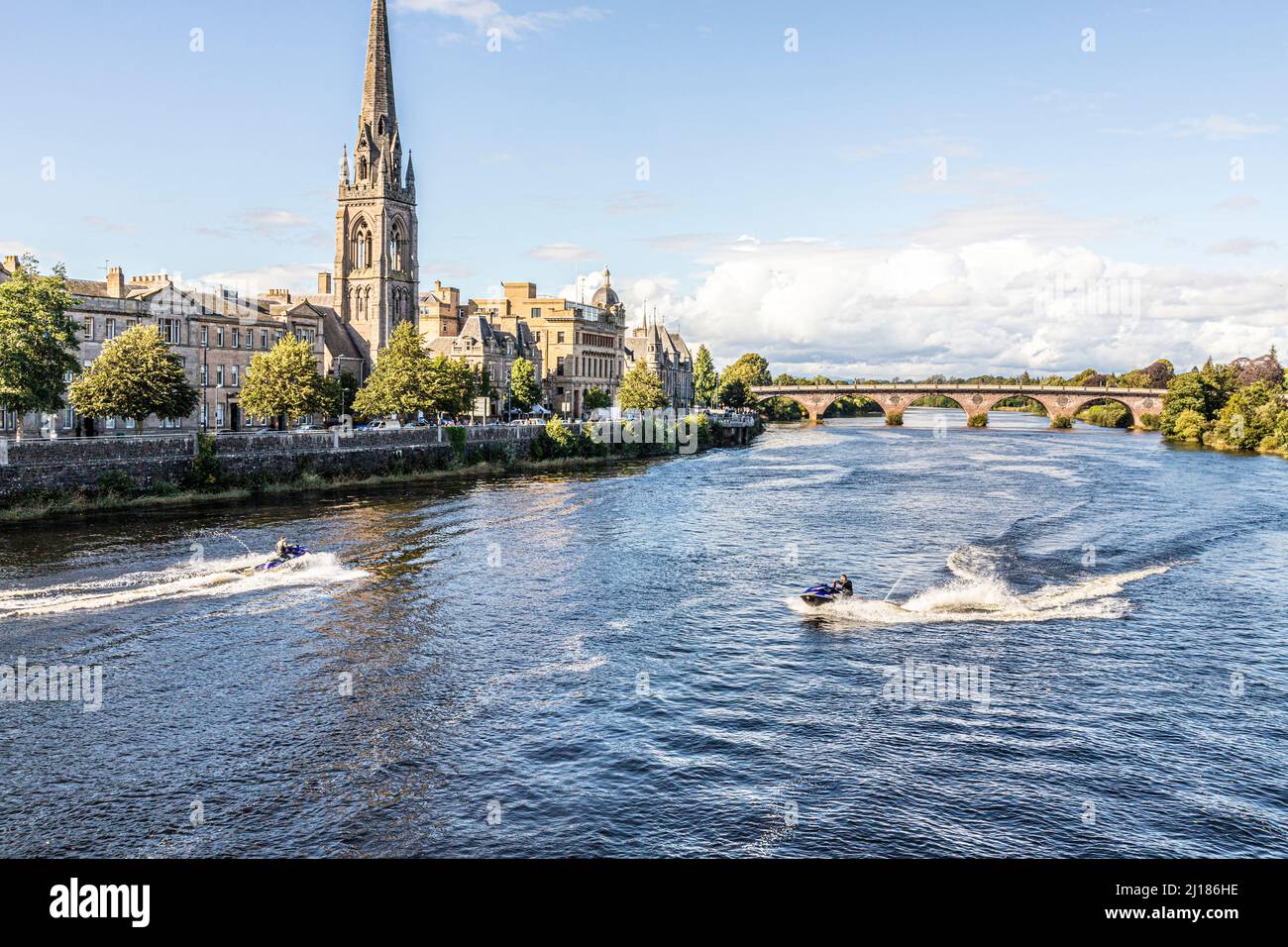 St Matthews Church beside the River Tay plus jetskiing on a peaceful Sunday afternoon in the city of Perth, Perth and Kinross, Scotland UK Stock Photo