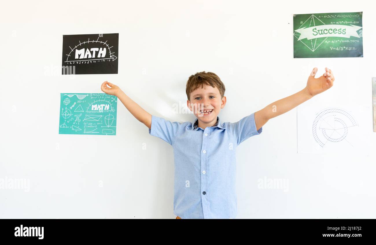 Portrait of smiling caucasian elementary schoolboy with arms ...