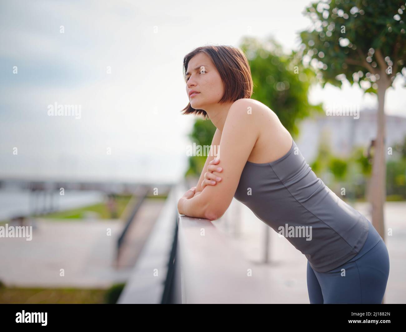 asian young strong, confident woman in sportive clothes feeling bad