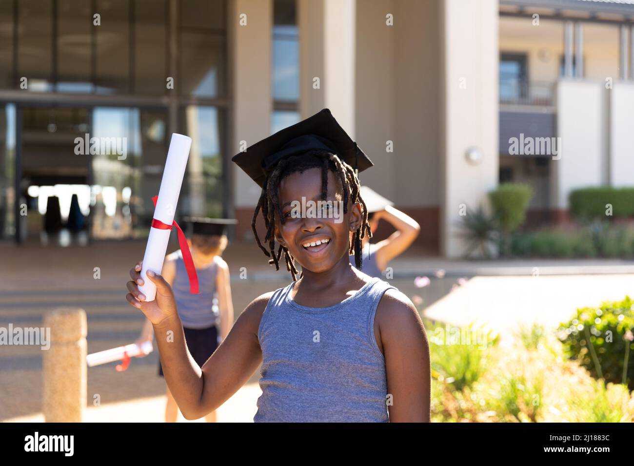 Portrait of smiling african american elementary schoolboy wearing ...
