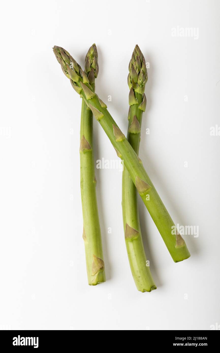 Directly above view of three asparagus on white background Stock Photo