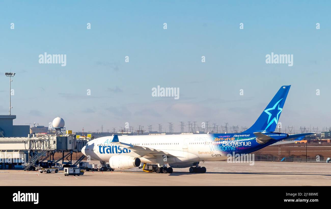 An Air Transat branded plane is seen in the boarding area of Pearson International Airport. The airport is the busiest and largest in the country. Stock Photo