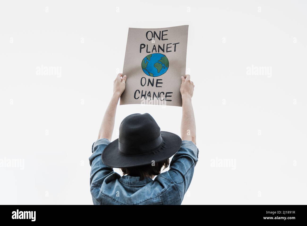 Young activist marching and protest for climate change holding banner - Demonstration for Ecology and environment concept Stock Photo