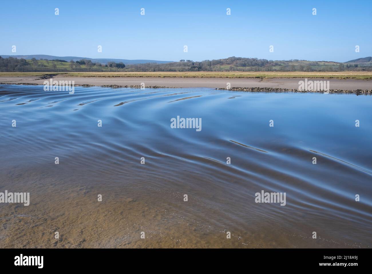 View of the River Nith as the tidal bore rushes past the village of Glencaple, Dumfries and Galloway, Scotland. Stock Photo