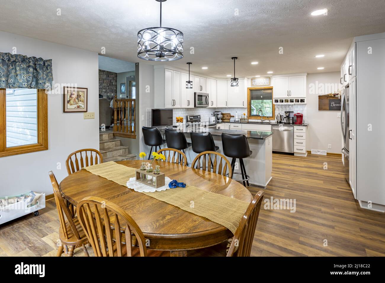 The dining room and kitchen with wooden floor of a cozy house in