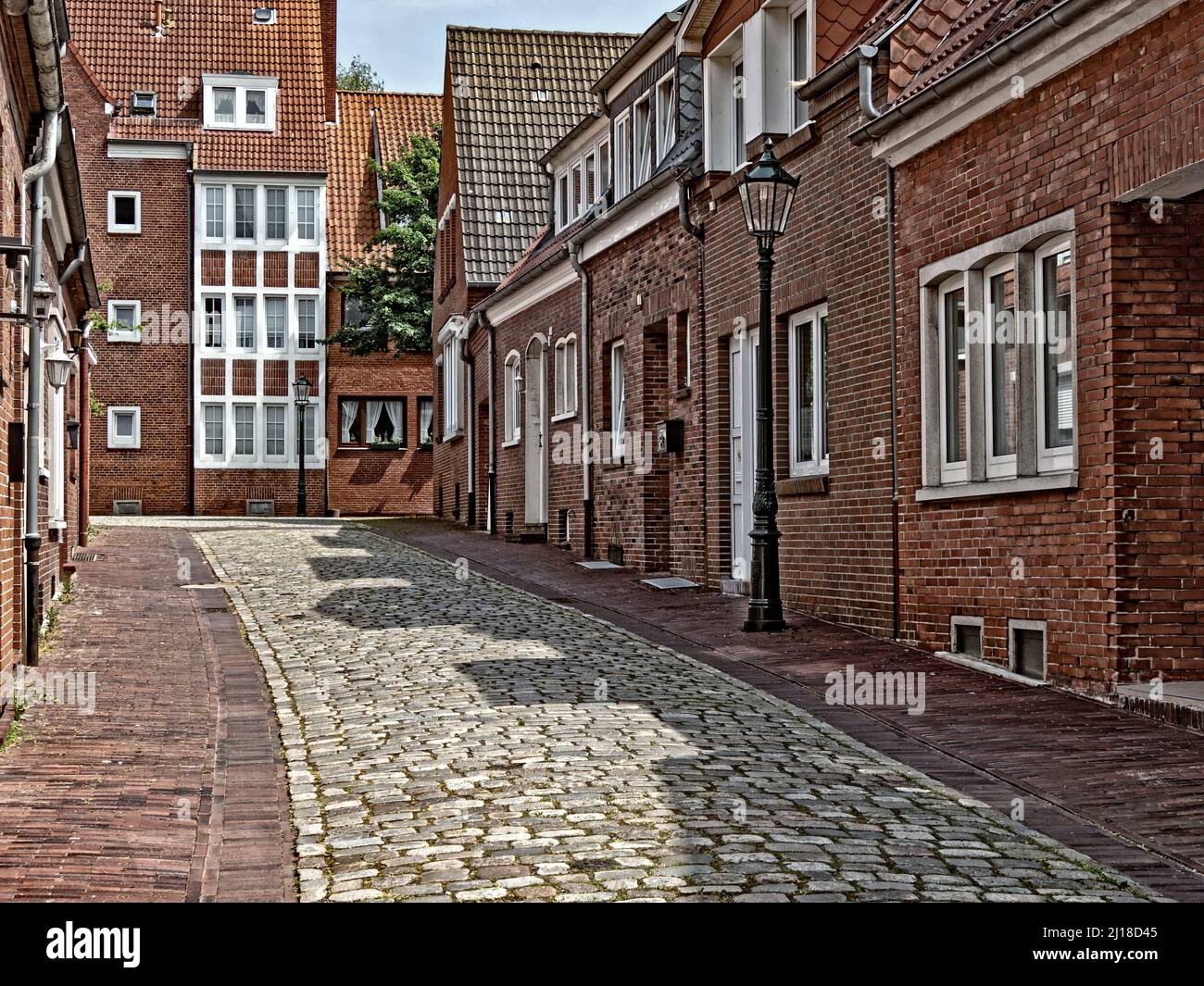 Street with brick houses in the old town of the East Frisian city of Emden, Germany Stock Photo