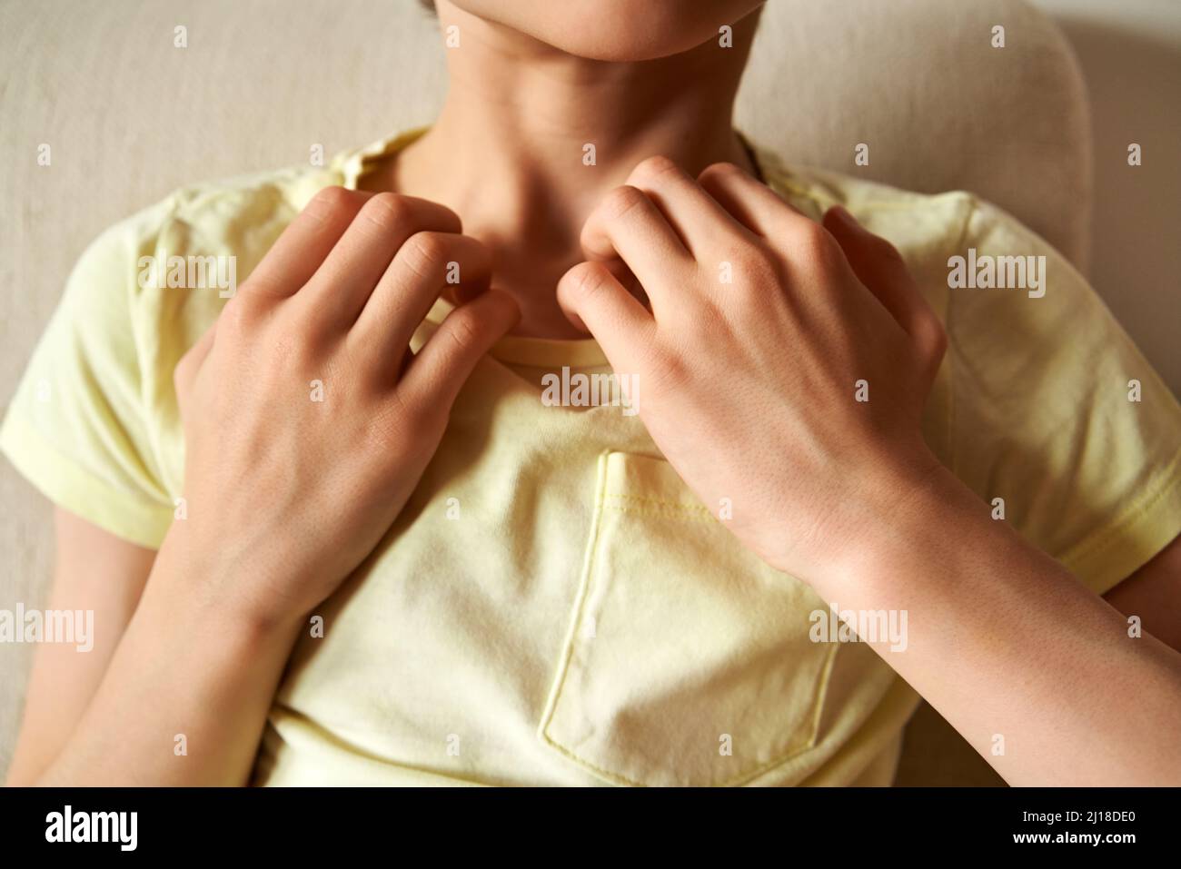 Young child practicing EFT or emotional freedom technique - tapping on the collarbone point Stock Photo