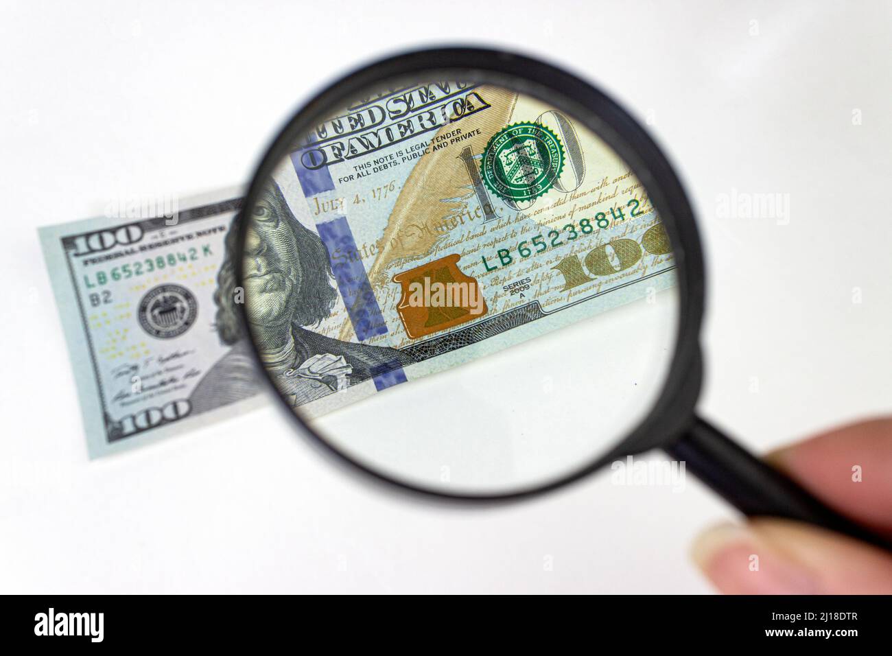 Magnifying Glass - 100 US Dollars. Hundred dollar bill under a magnifying glass Stock Photo