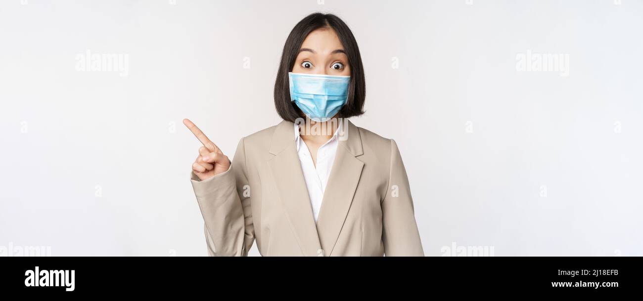 Coronavirus and work concept. Portrait of woman in medical face mask ...