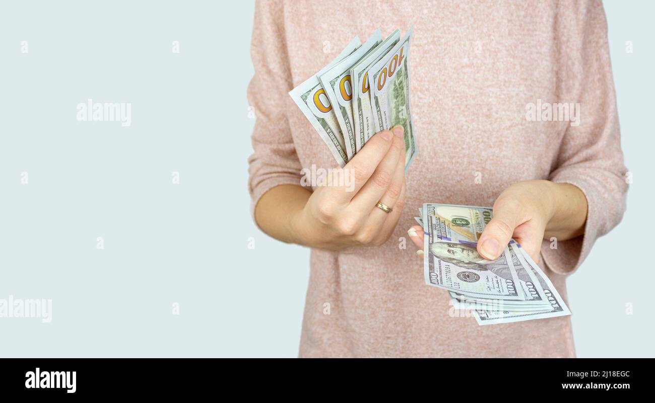 American dollars or US dollars: hand counting one hundred American money or 100 USD Stock Photo