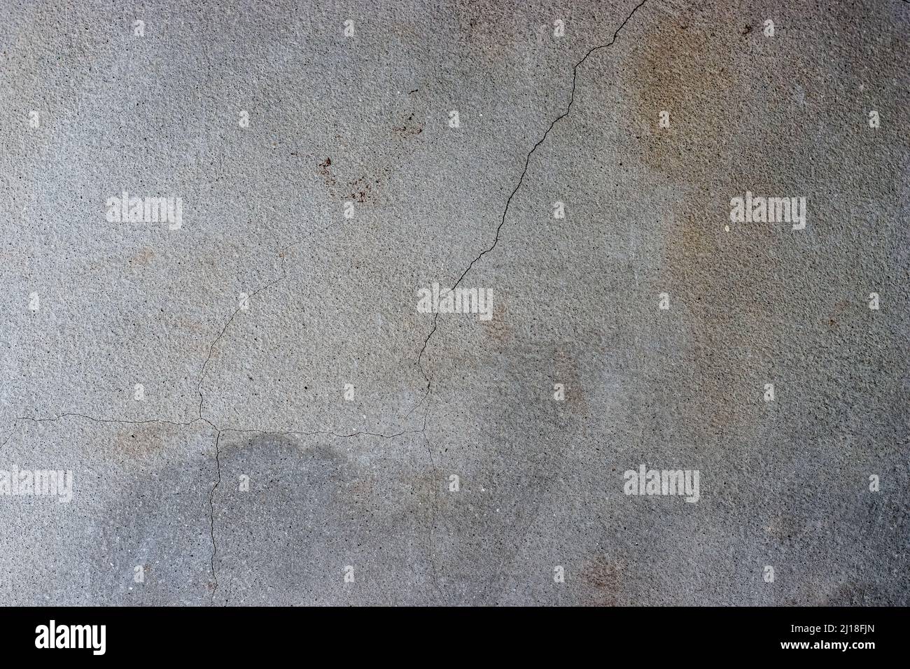 Dark gray cracked concrete plaster wall surface with rustic grunge texture Stock Photo
