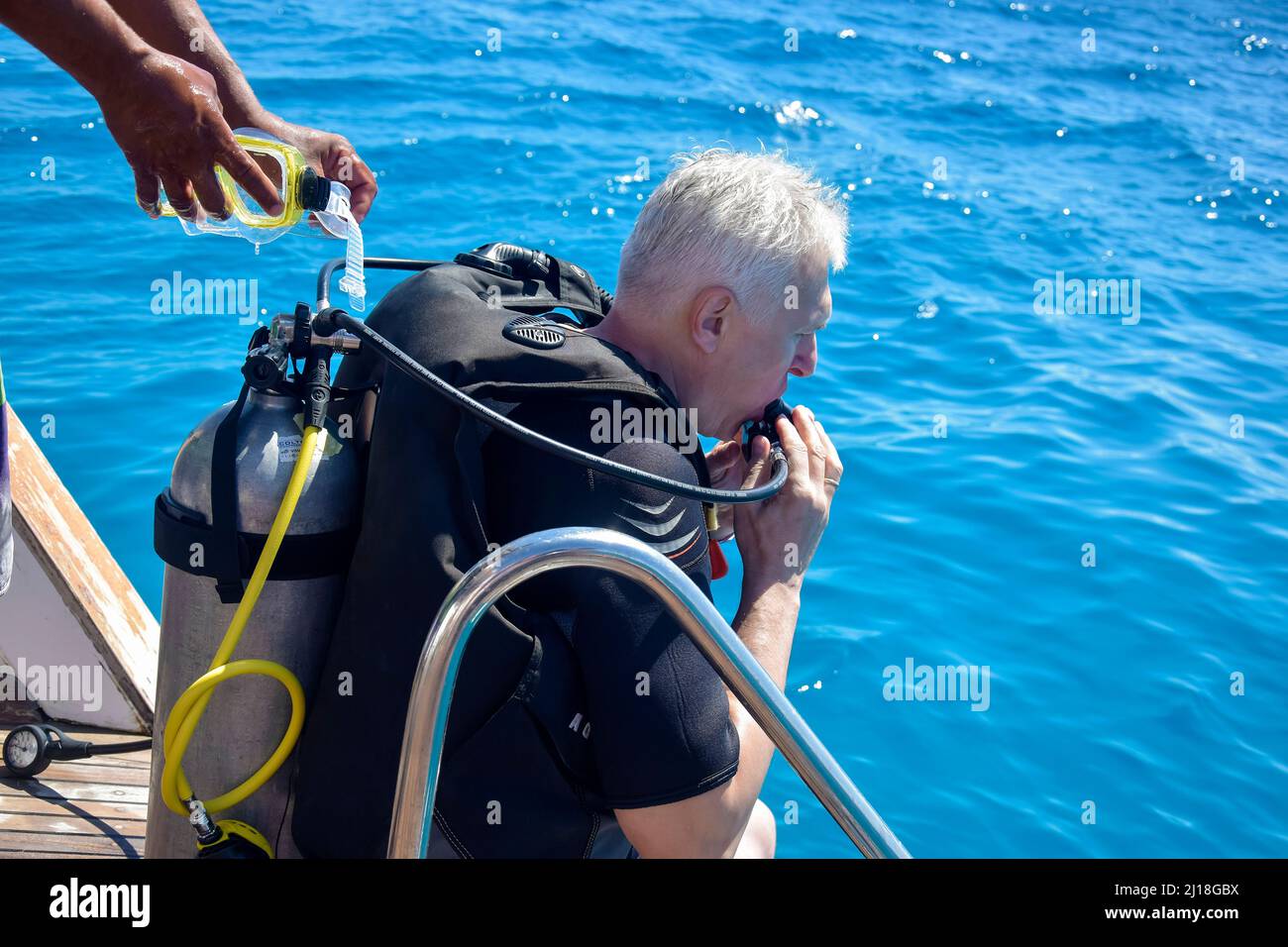 Scuba diver before diving. Diving lesson in open water. Male in scuba