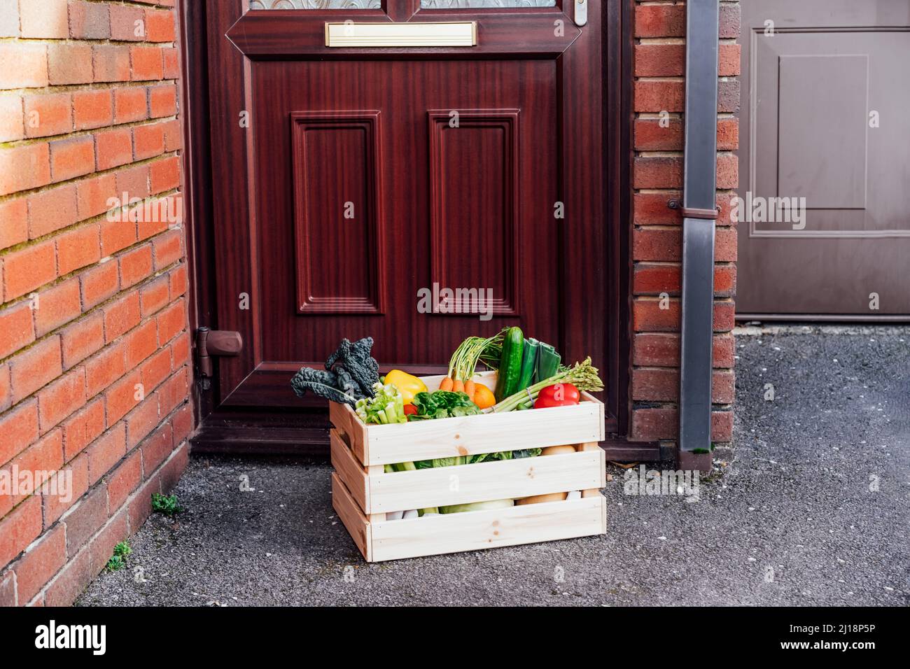 Contactless home fresh food delivery. Wooden box with vegetables and