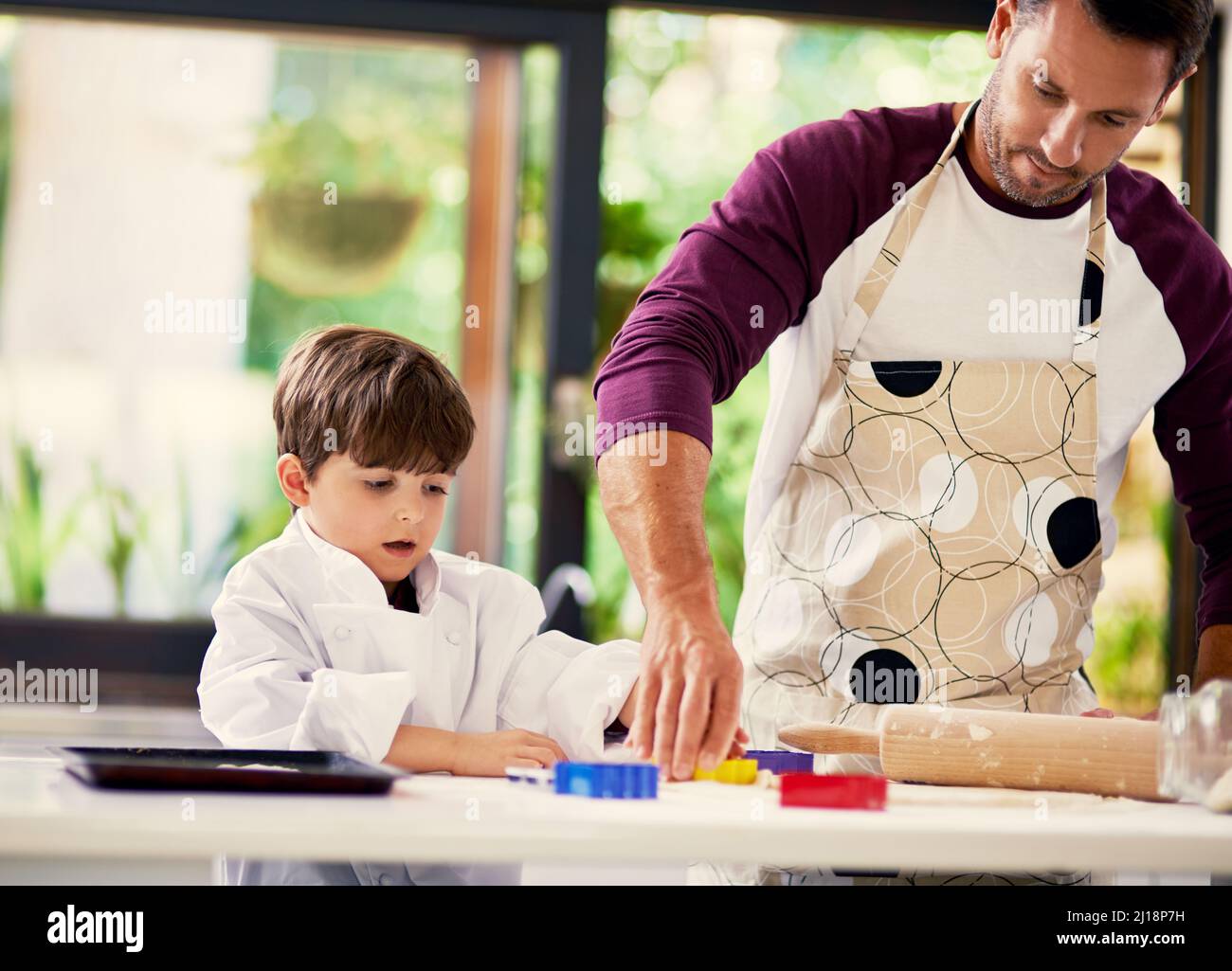 Cookies are made of butter and love. Shot of a father and son baking biscuits in the kitchen. Stock Photo