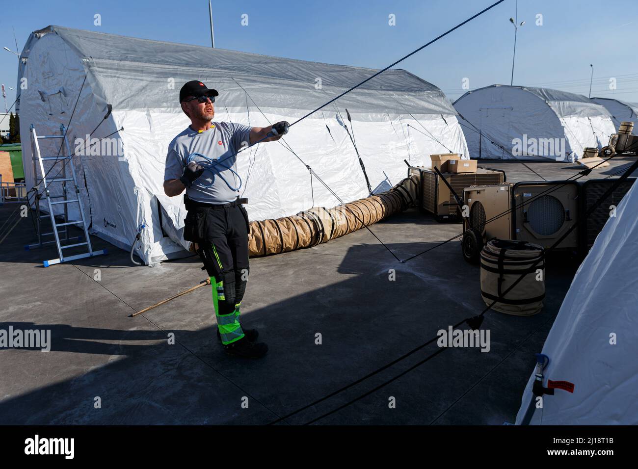 SOLOMONOVO, UKRAINE - MARCH 22, 2022 - A labourer is seen at work to set up a tent camp for internally displaced persons who fled the attacks of Russi Stock Photo