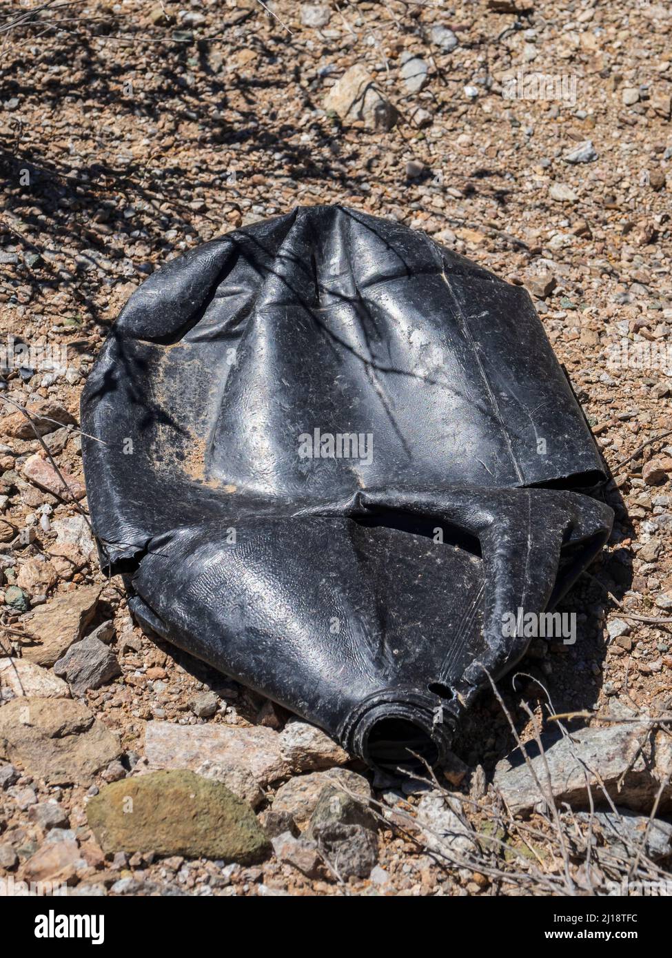 Non-reflective black water jug used by smuggler or illegal immigrant, Milton Mine Trail, Organ Pipe Cactus National Monument, Arizona. Stock Photo