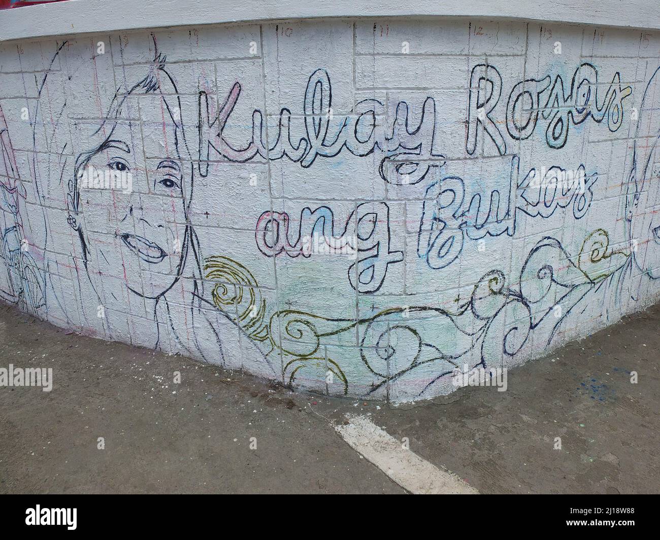 Full view of the unfinished outline artwork with a face of Presidential  aspirant Leni Robredo. Fine Arts Students from different universities in  Manila collaborated to put up mural paintings dedicated to the