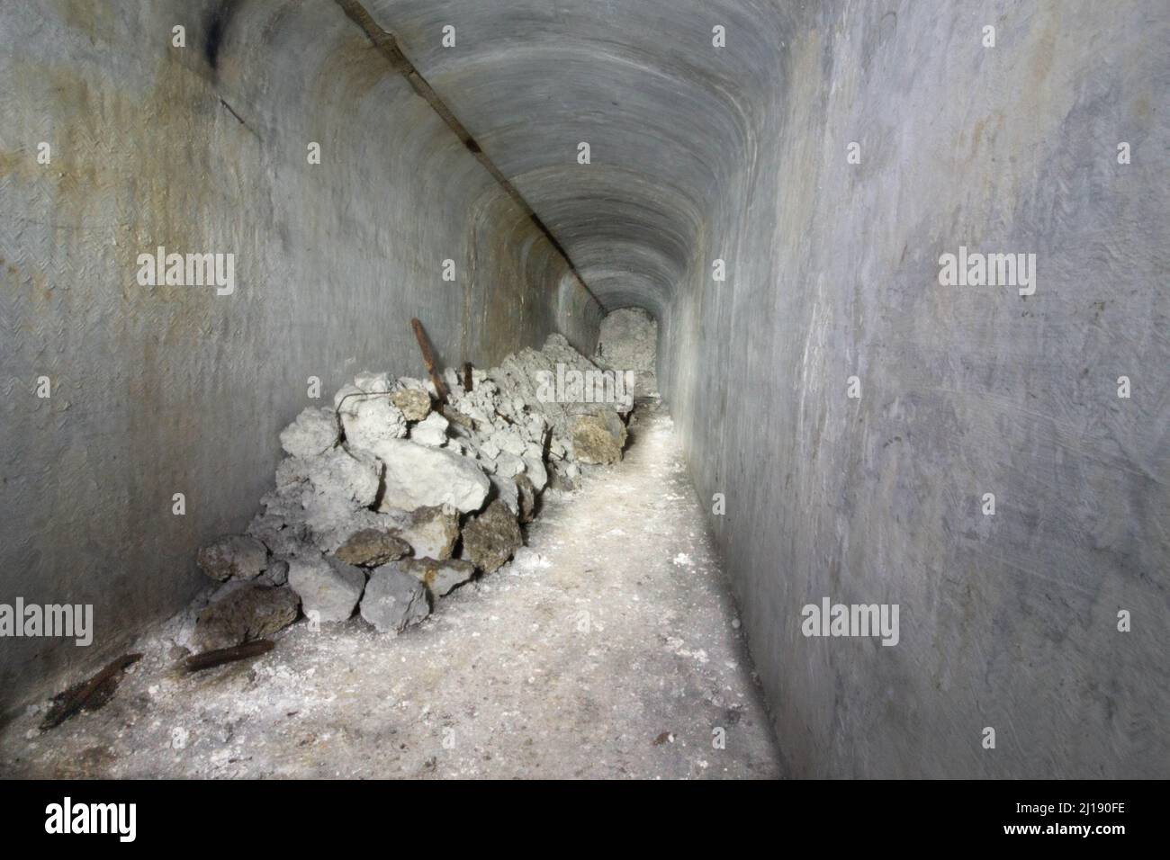 The hidden tunnel Air Raid Shelter with giant stones in it Stock Photo