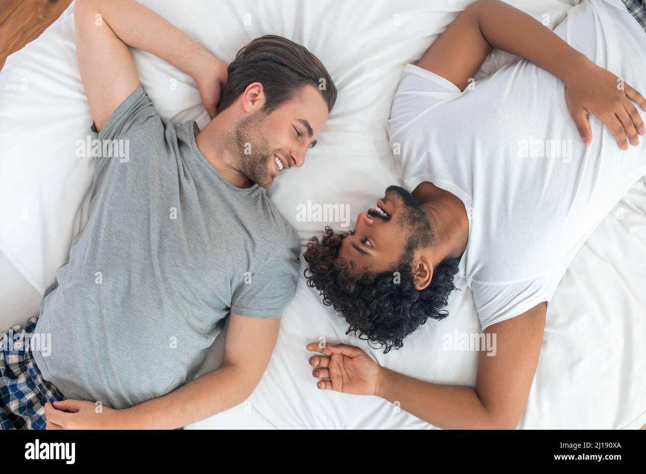 Two men in love lying in the bedroom Stock Photo - Alamy