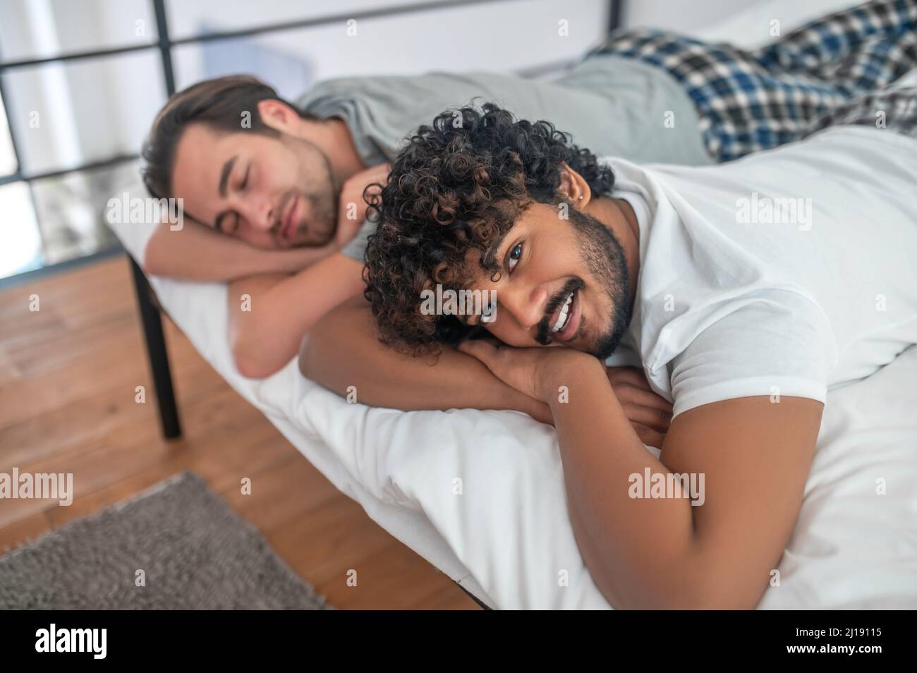 Male and his boyfriend resting in their bedroom Stock Photo