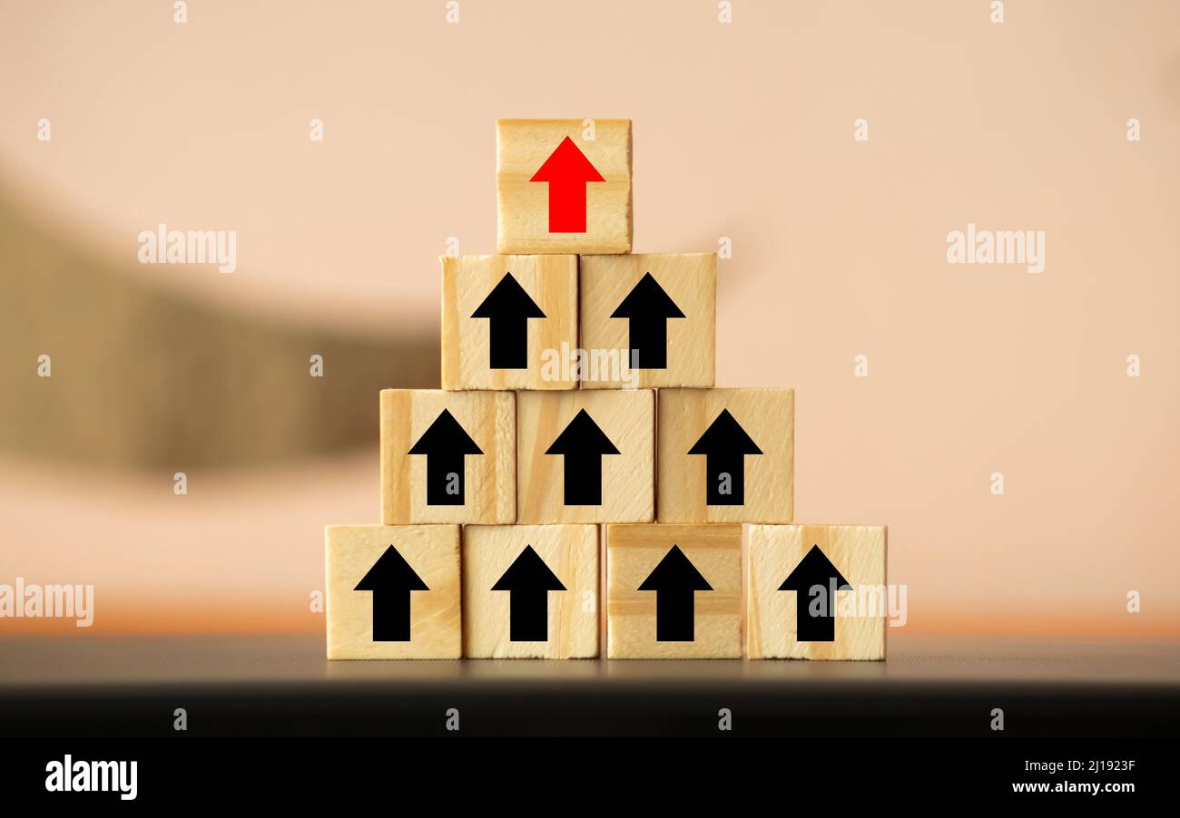Hand arranging wood block stacking as step stair with arrow up. Ladder ...