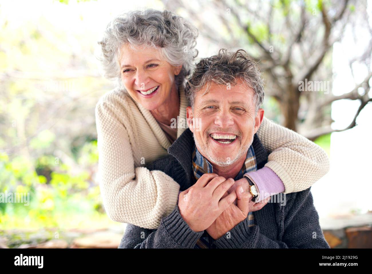 Lovely light-hearted moments together. Portrait of a happily married senior couple bonding outside. Stock Photo
