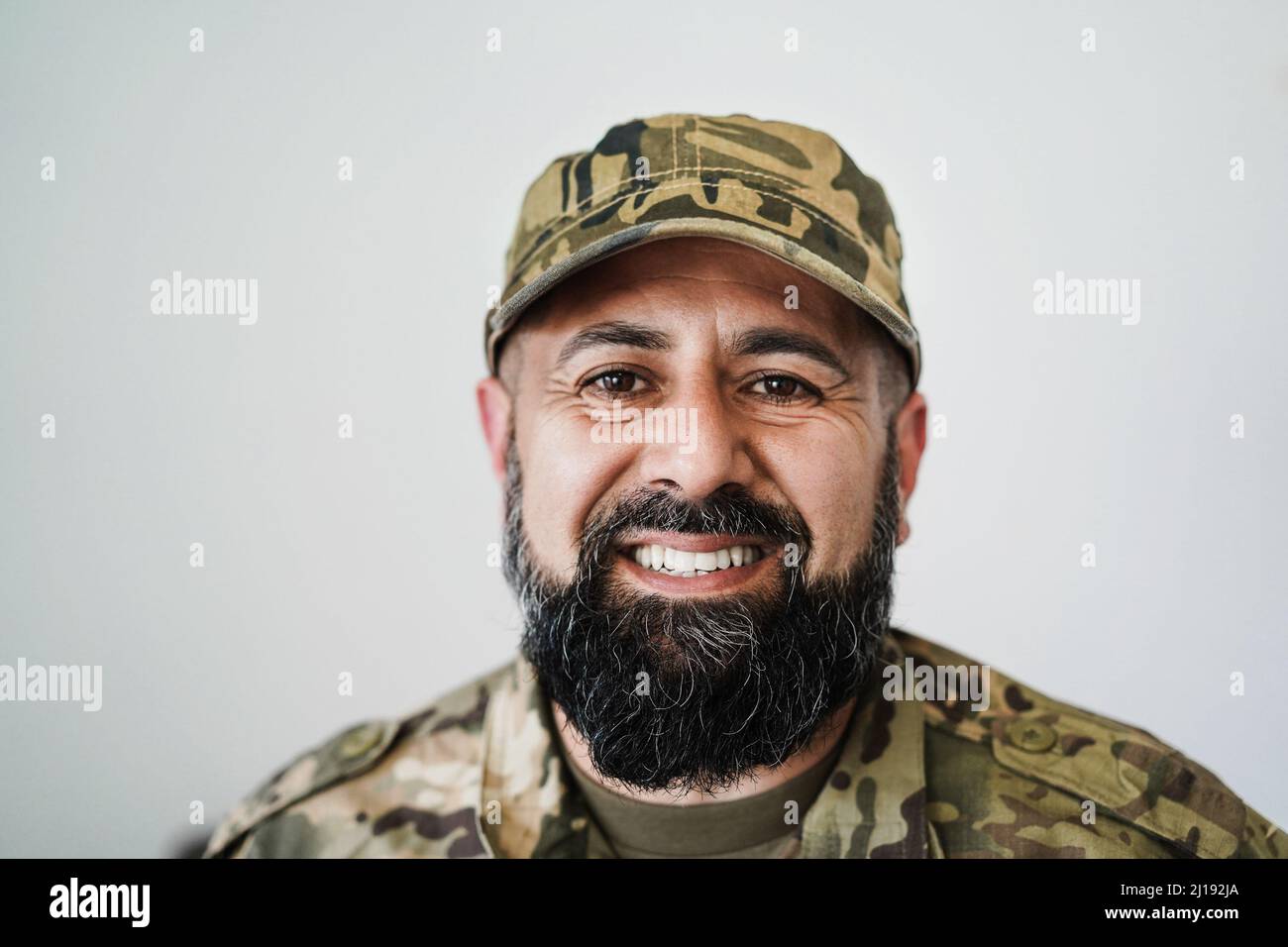 Happy male soldier looking at camera - Focus on beard Stock Photo