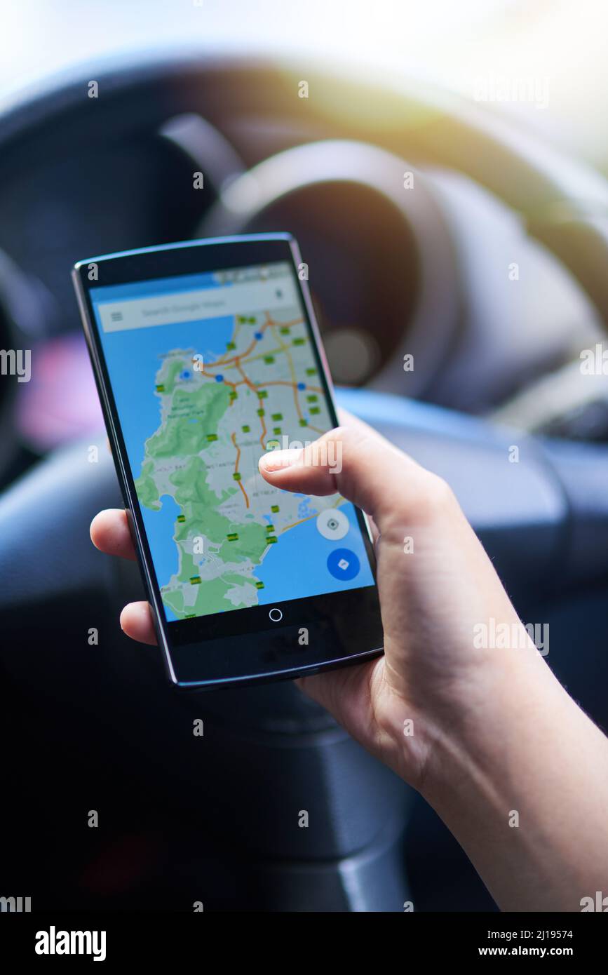 Navigation made easy. Shot of a person in a car using their phone to