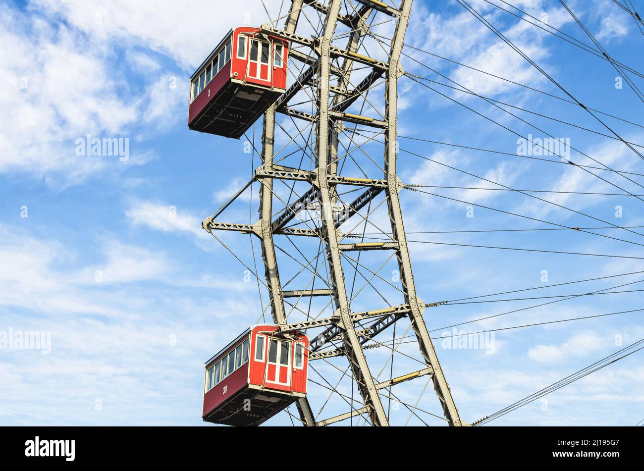A Ferris wheel with red cabins of the Prater amusement park in Vienna ...