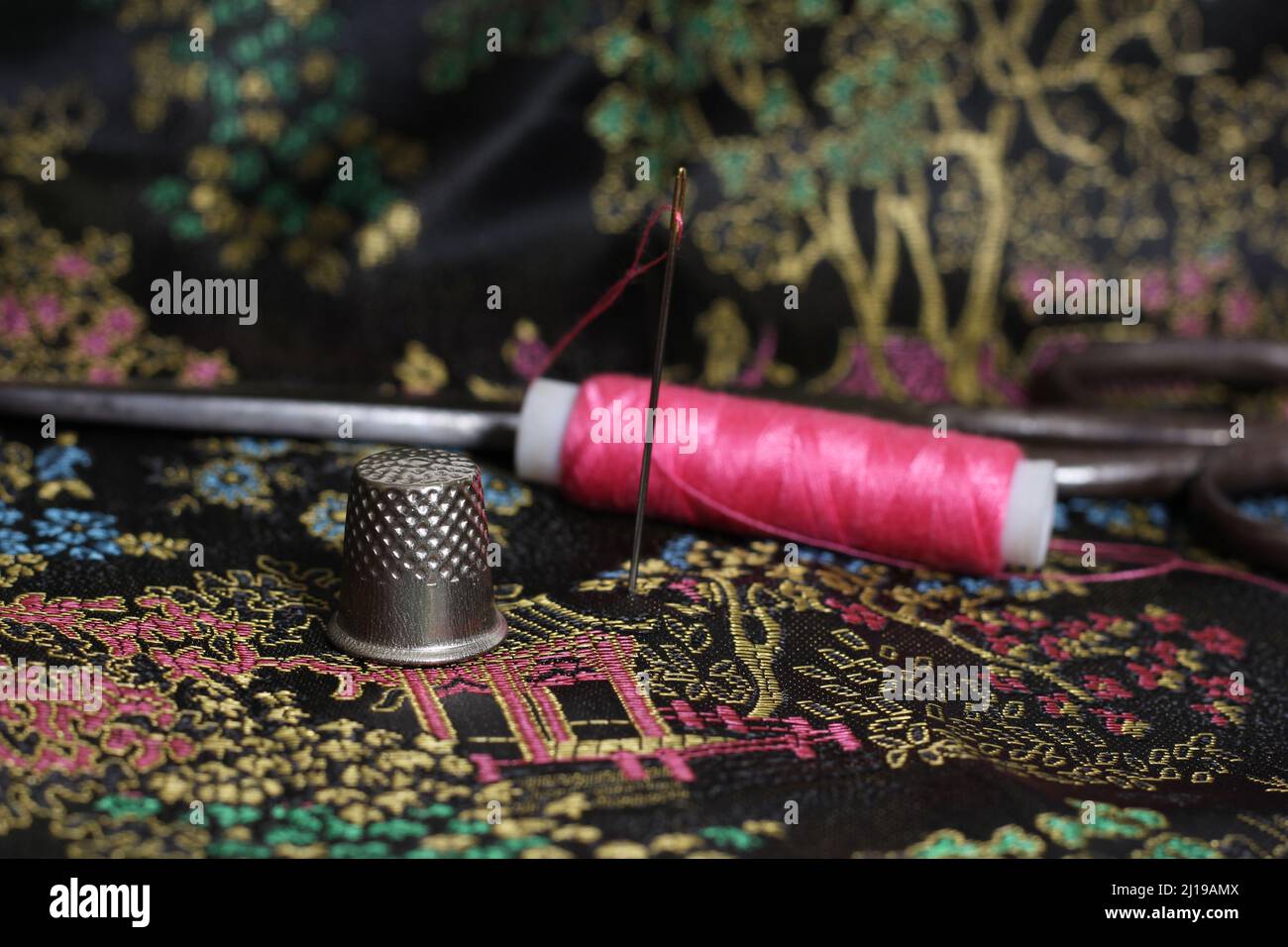 Pink Thread and Thimble on Vintage Chinese Silk Stock Photo Alamy