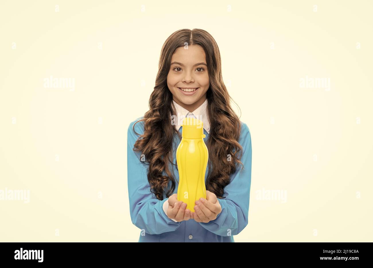 Enjoy yogurt for breakfast. Happy child hold yellow bottle isolated on white. Enjoy every sip Stock Photo