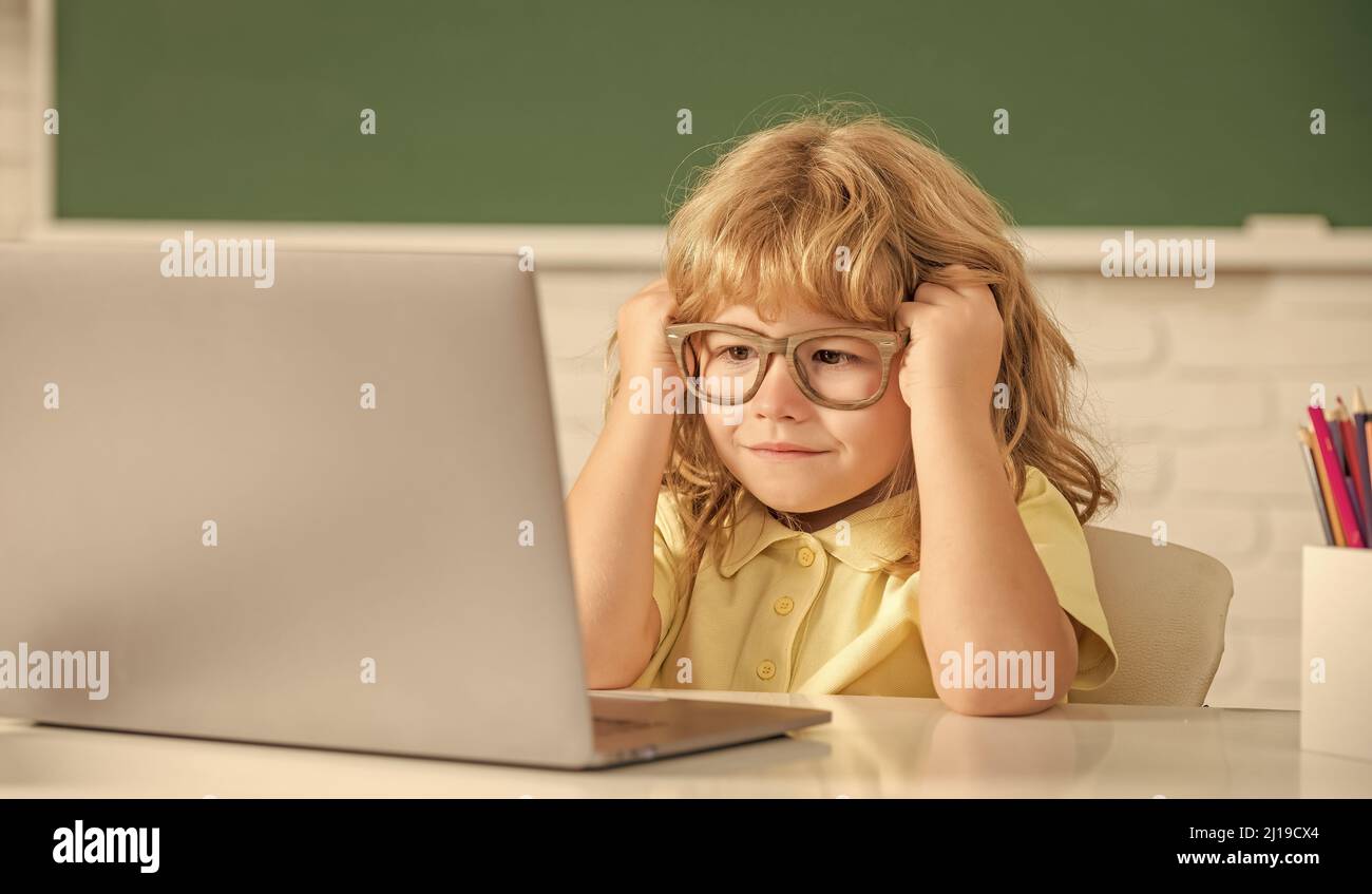 knowledge day. concept of online education. nerd kid in glasses with